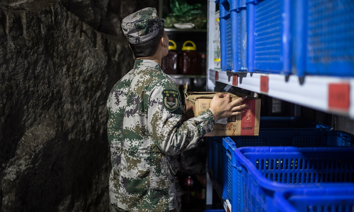 A soldier sorts through the food storage in Zhanniangshe post. Photo: Shan Jie/GT